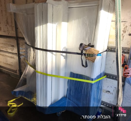 רהיטים עטופים ומאובטחים בתוך משאית הובלה